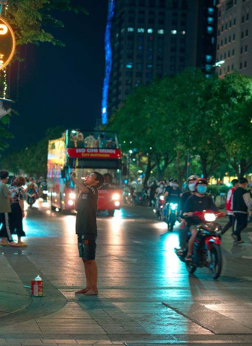 Free Vibrant night life in Ho Chi Minh City with bustling streets, traffic, and illuminated city lights. Stock Photo