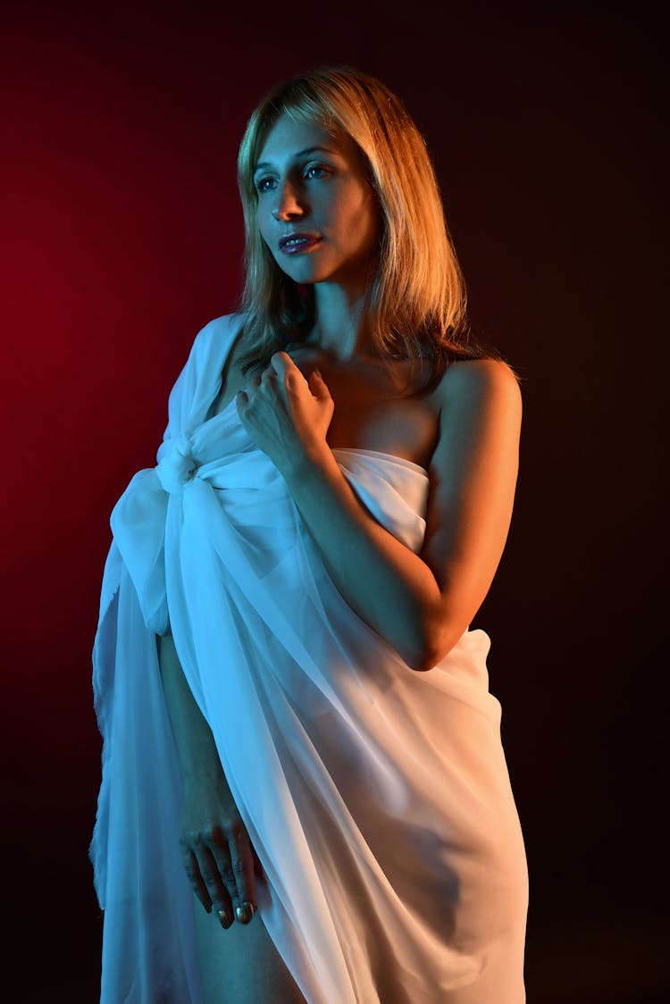Woman In Fabric Dress Posing In Studio