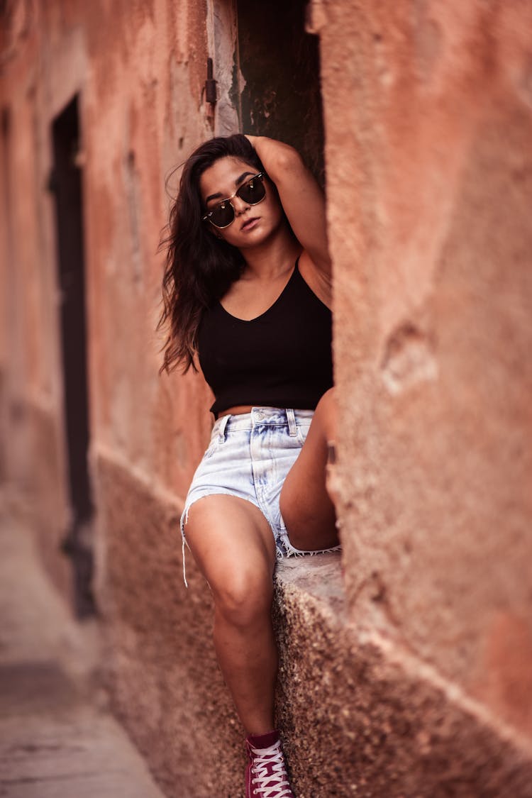 Woman In Black Tank Top Sitting Beside A Window