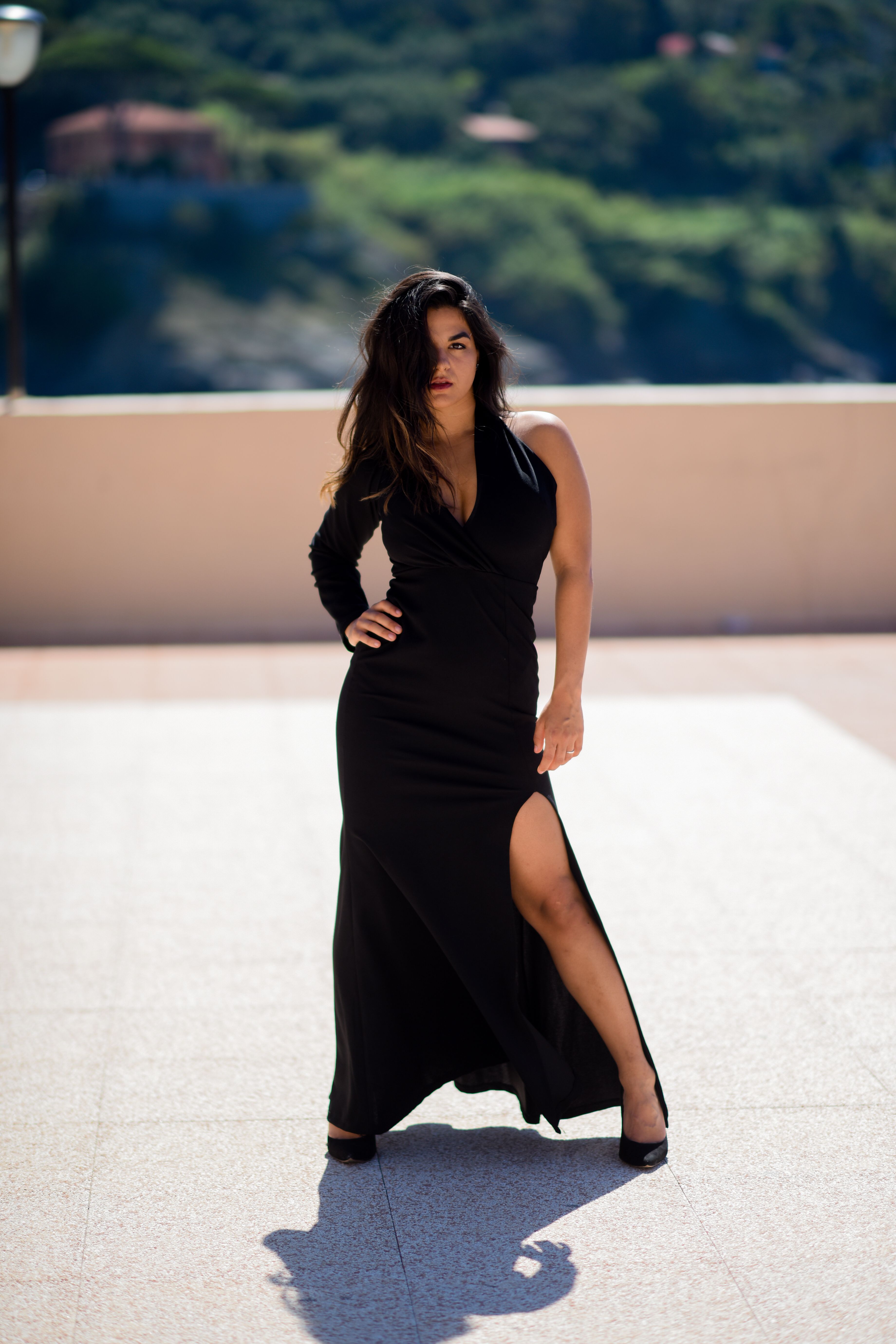 A Woman in Black Dress with Her Hand on Her Waist · Free Stock Photo