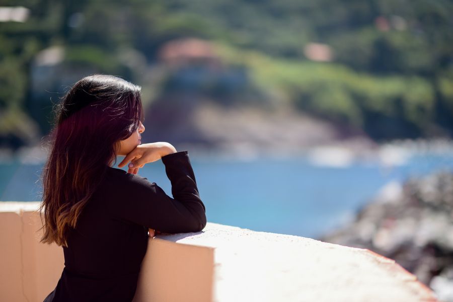 Woman looking out over a calm sea