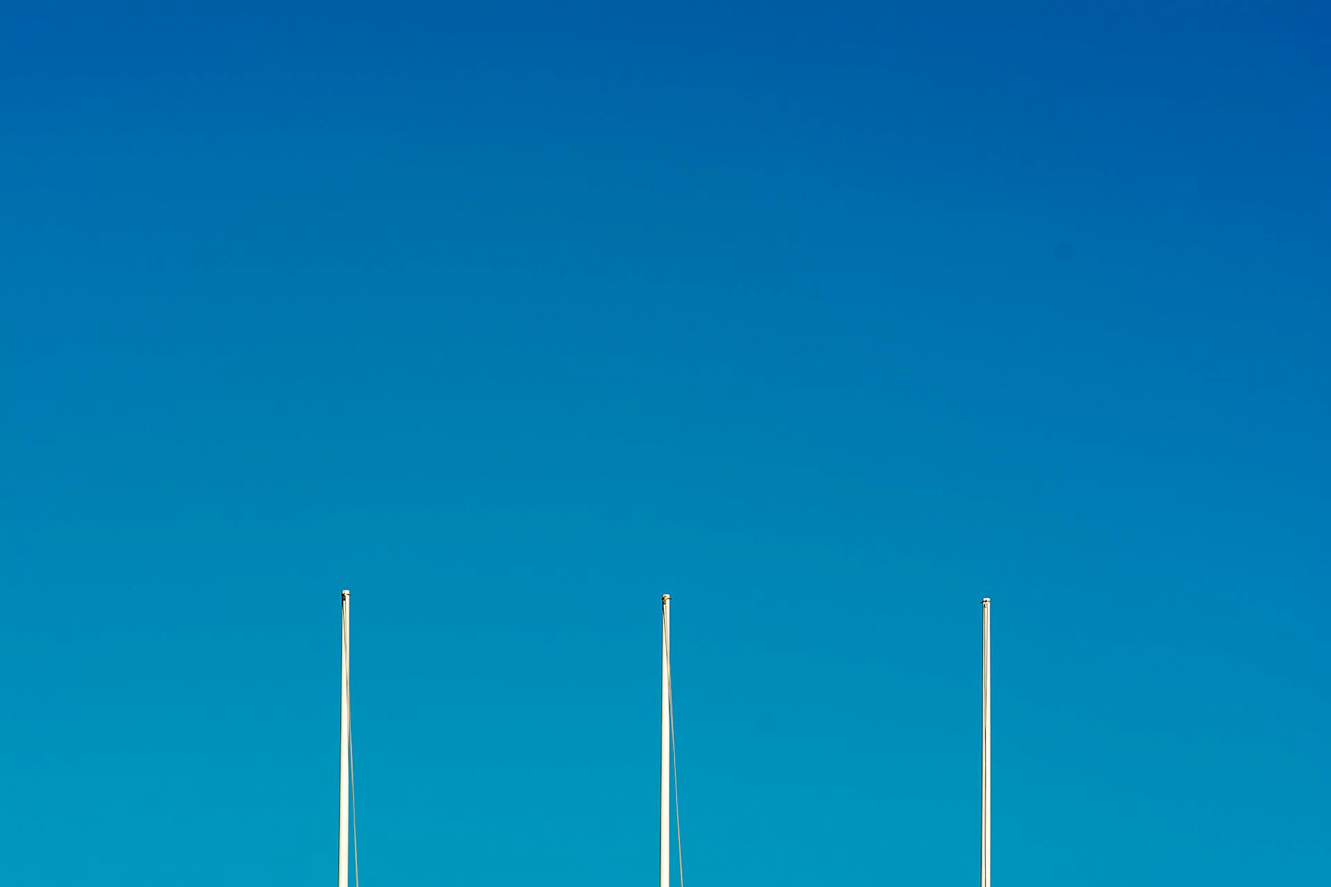 White Metal Poles Under Blue Sky