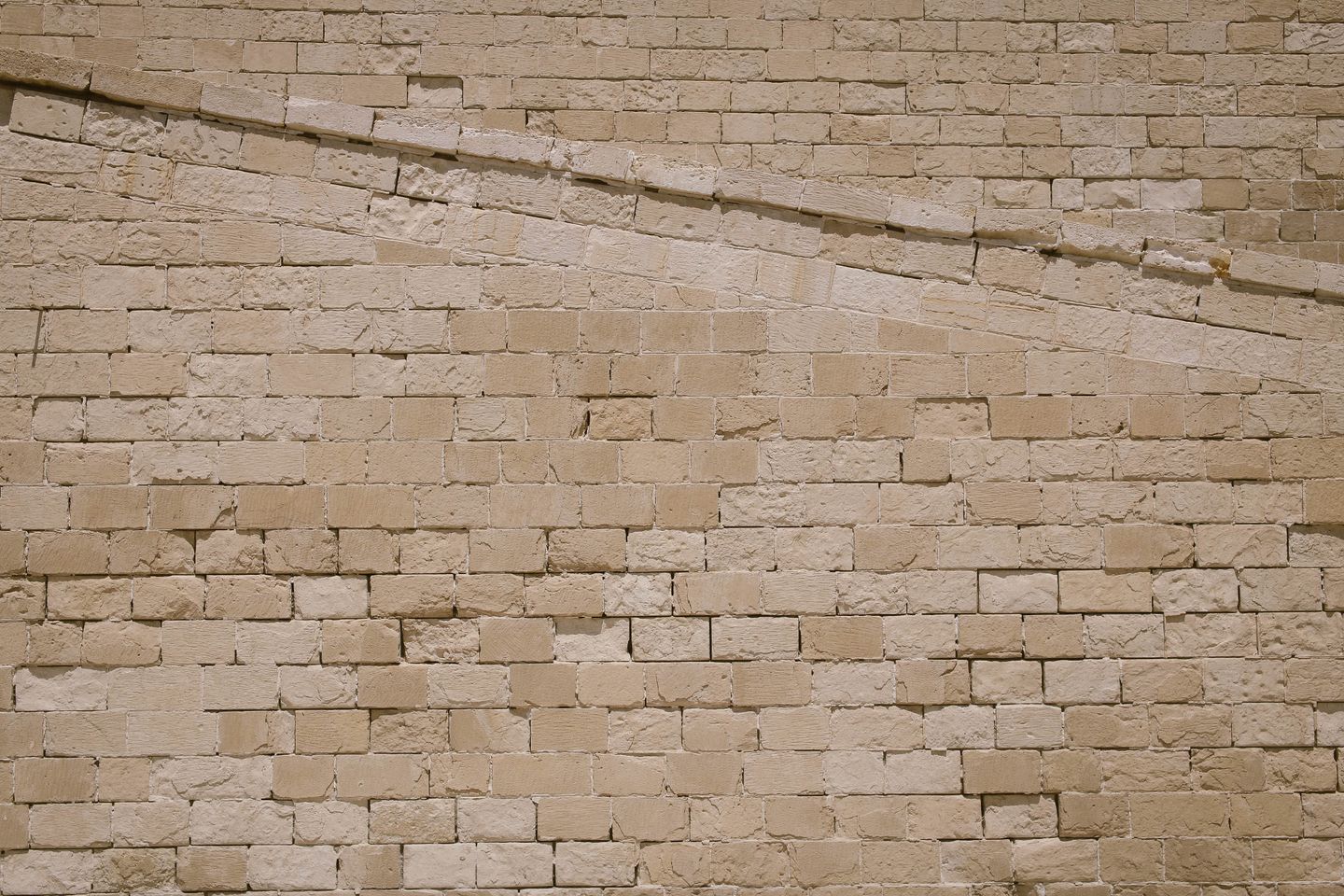 Close-up of beige stone brick wall texture
