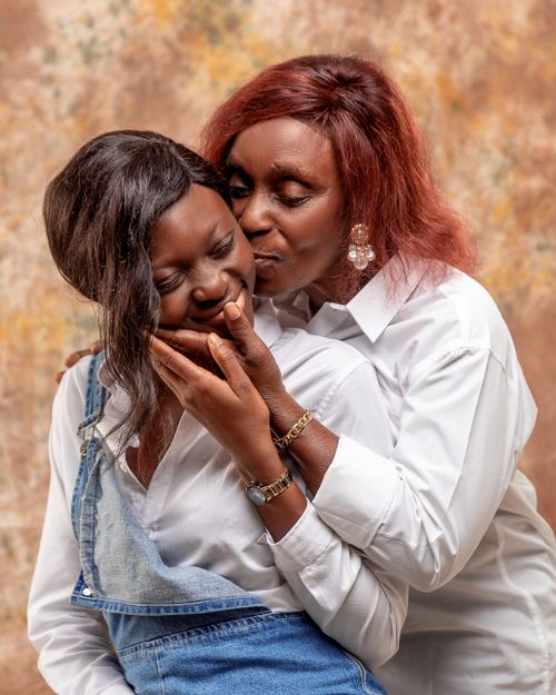 Free A loving moment between mother and daughter wearing white, captured indoors. Stock Photo