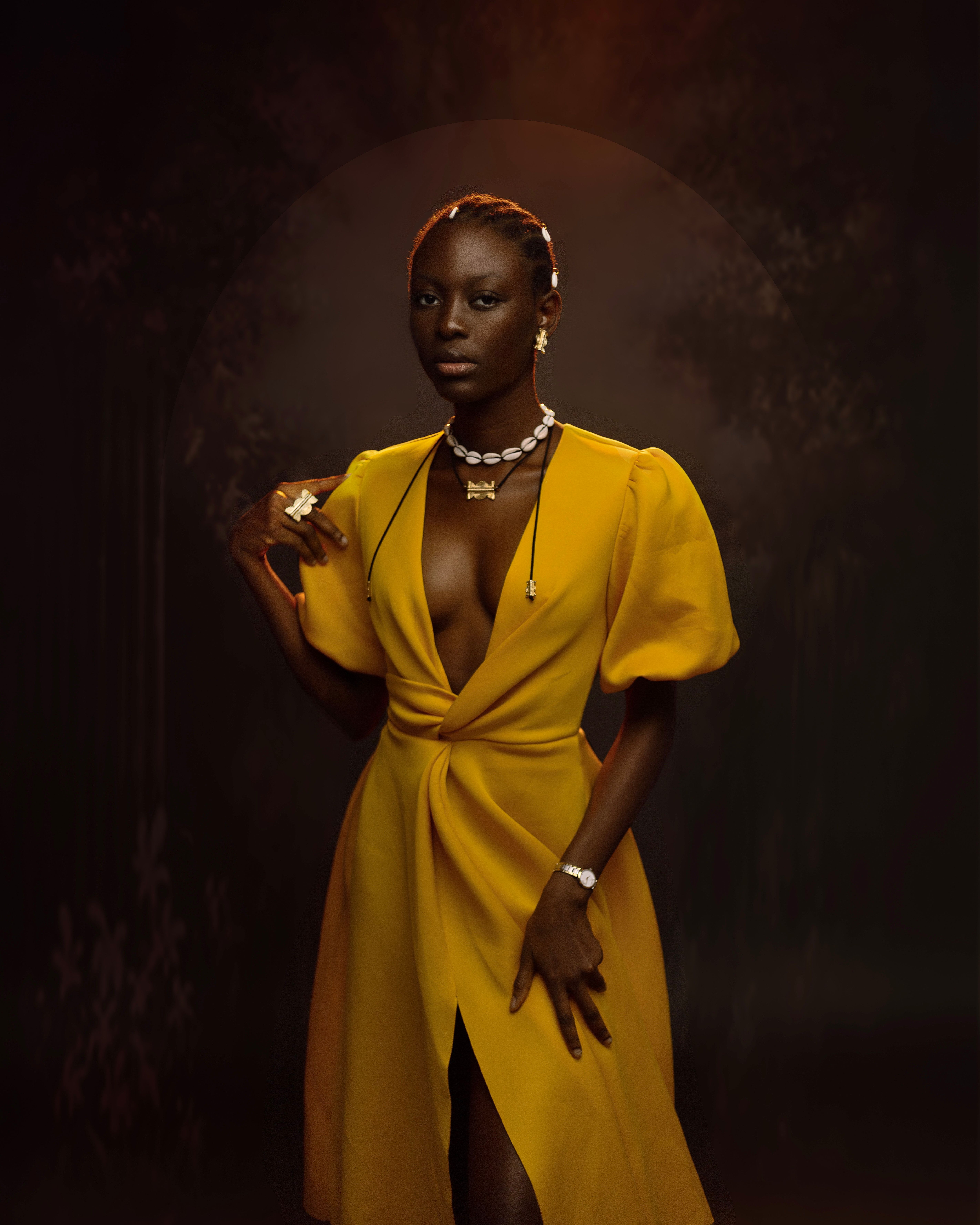 Woman posing in elegant yellow outfit, Côte d'Ivoire
