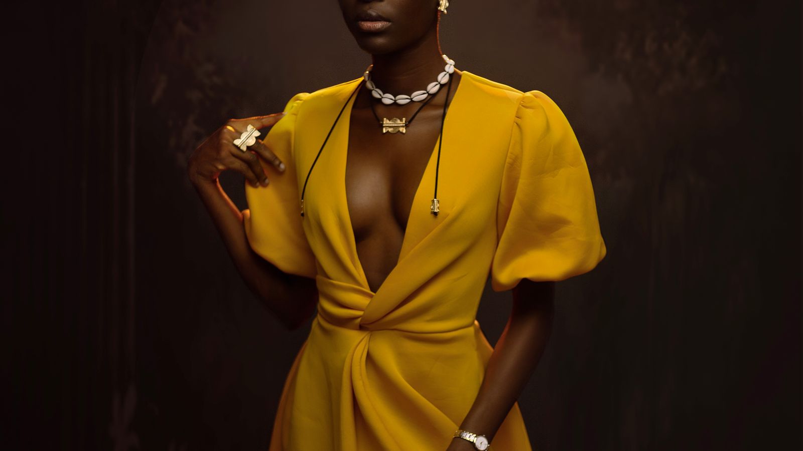 Woman posing in elegant yellow outfit, Côte d'Ivoire