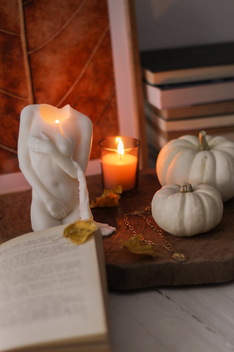 Candles And Book On Table