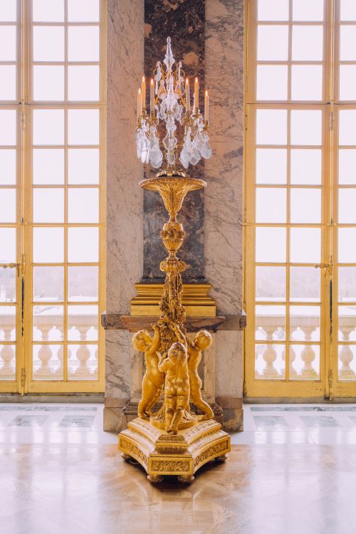 Free Majestic golden candelabra in the opulent interiors of the Palace of Versailles, France. Stock Photo
