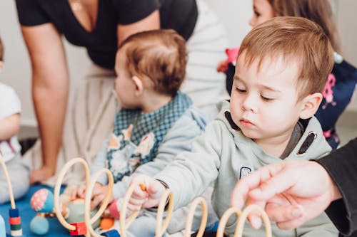 Photo of a Boy Playing with a Spiral Toy