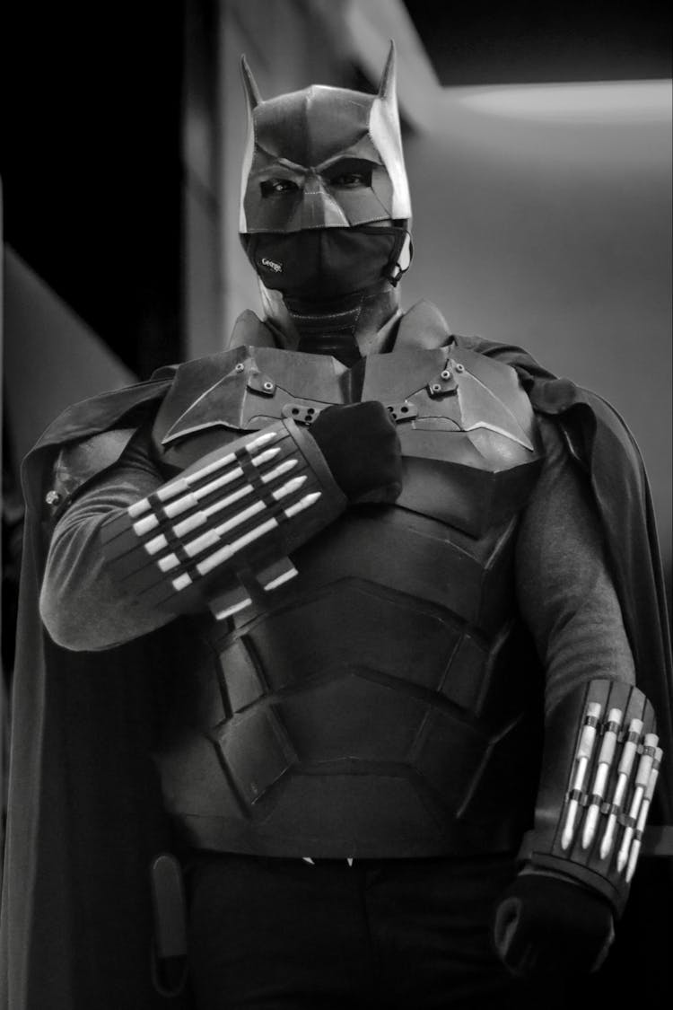 Grayscale Photo Of A Man Wearing A Batman Costume