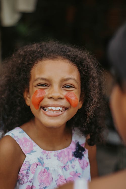 A Girl with Red Face Paint