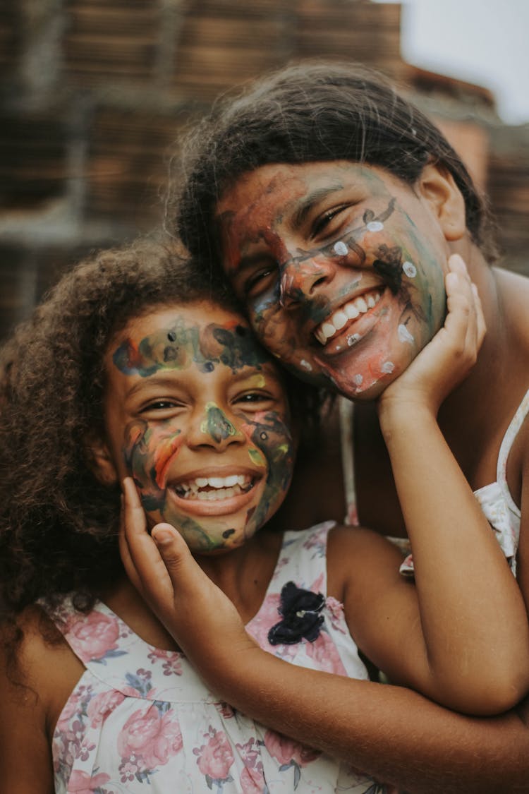 Girls With Painted Faces Hugging 