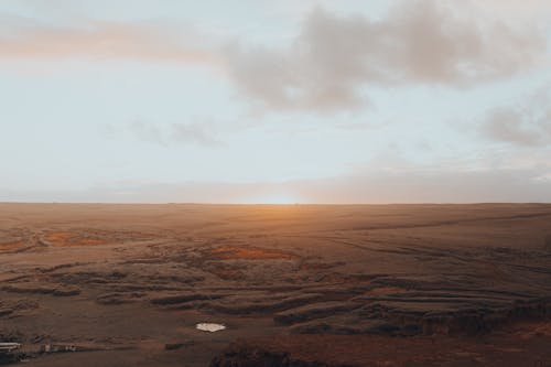 Free Brown Field Under White Clouds Stock Photo