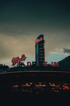 Vintage diner with neon signs illuminated at twilight in Orlando, Florida.