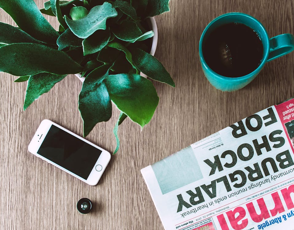 Free Iphone On Brown Wooden Table Stock Photo