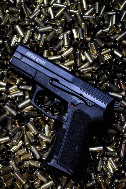 Close-up of a Pistol on Bullets