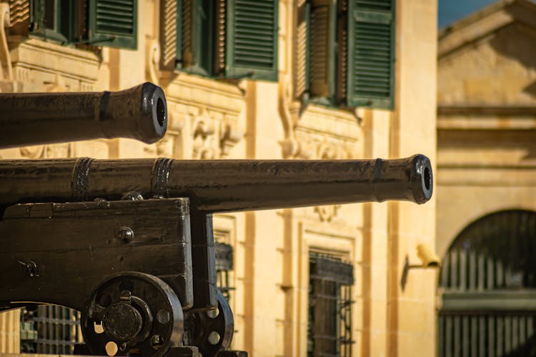 Brown Cannons Near The Concrete Building 