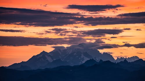 Black and White Mountains Under White Clouds