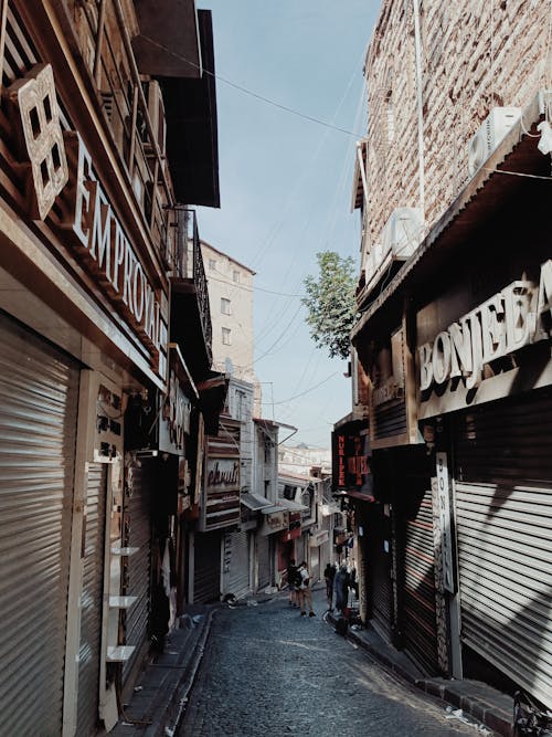 A Narrow Paved Alley Between Stores in an Old Town