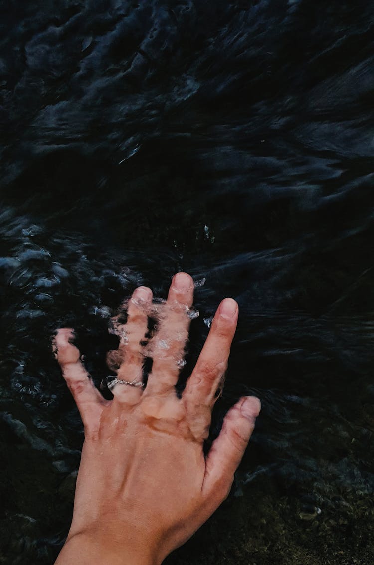 Person Putting Hand Underwater 