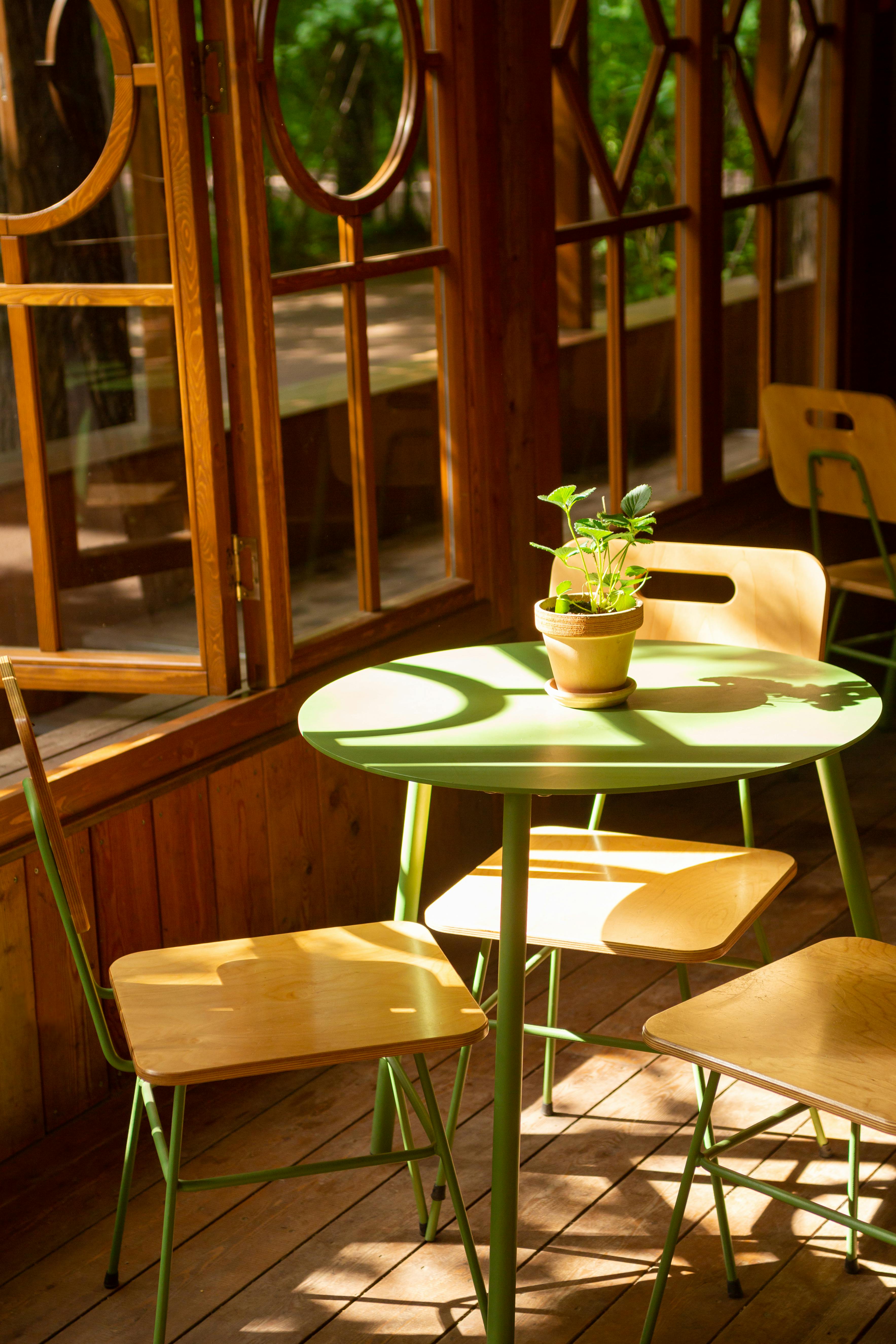 Cafe Table in a Wooden Interior Lit by the Sunlight · Free Stock Photo