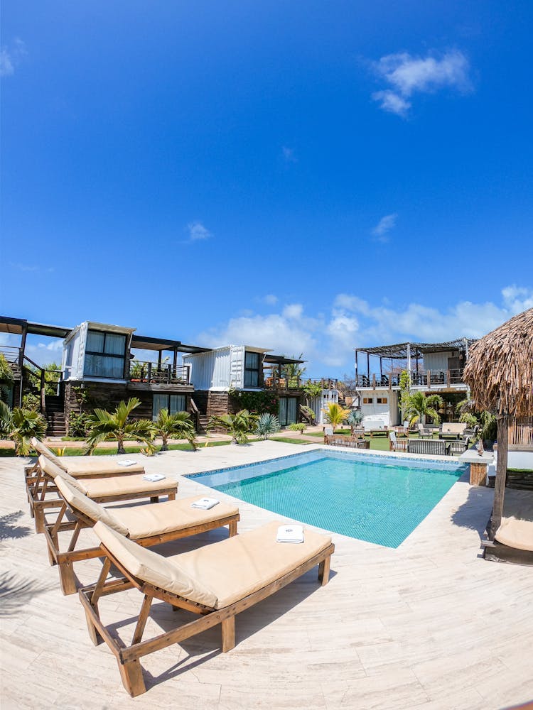 Sun Loungers Around The Pool In A Resort 