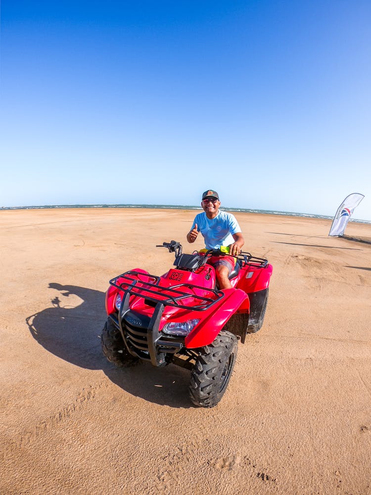 Man Riding A Red Atv