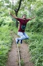 Jump Shot Photo of Man Near Tree