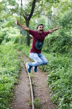 Jump Shot Photo of Man Near Tree