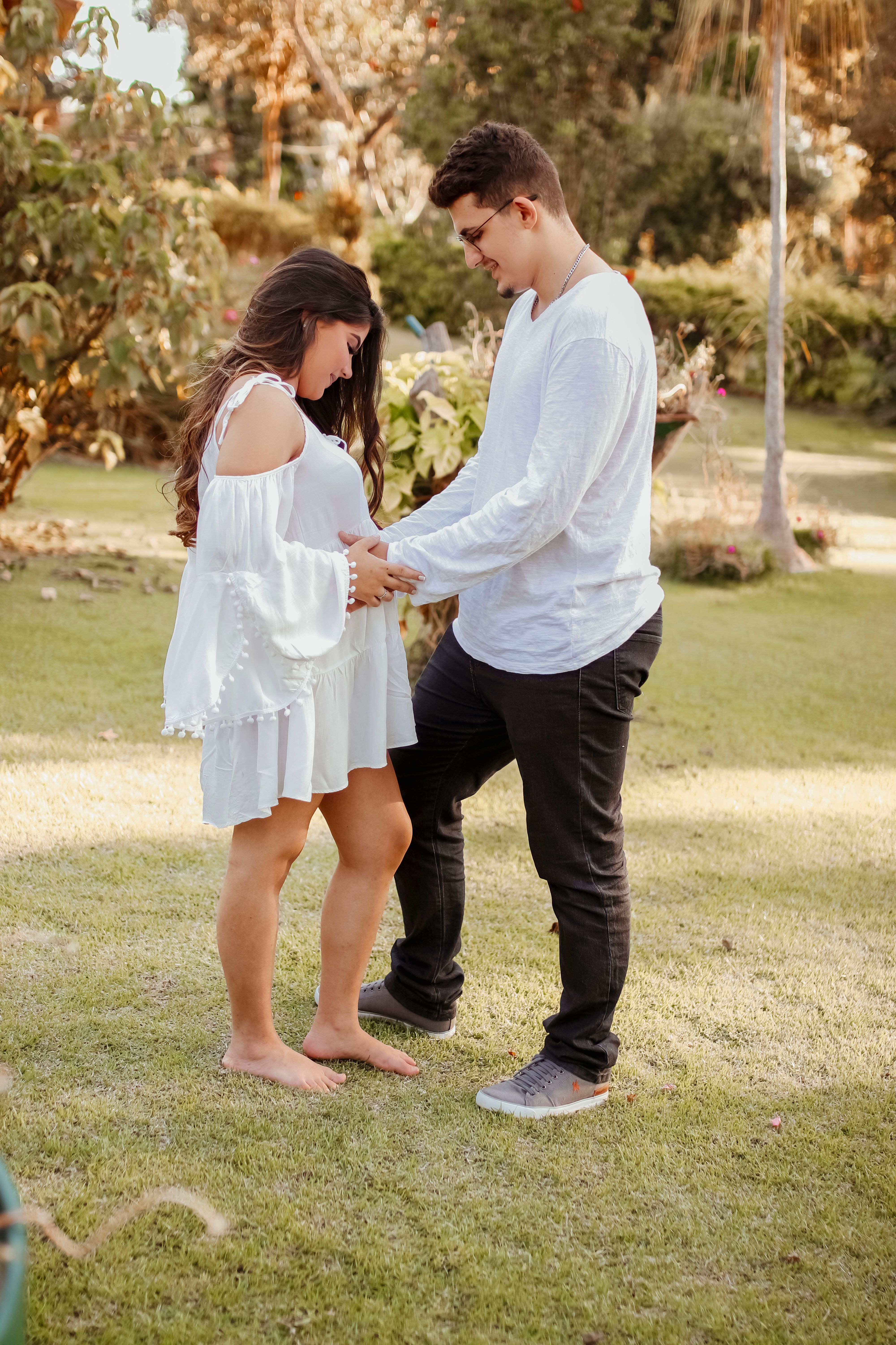 Man and Woman Holding Hands While Standing on Green Grass Field · Free ...