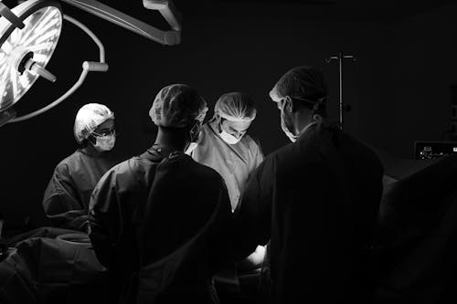 Free Doctors Performing a Surgery in the Operating Room Stock Photo