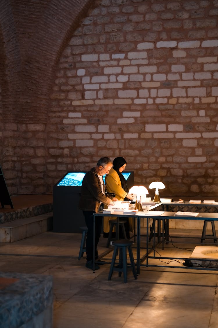 Man And Woman Standing In Front Of Table Lamps 