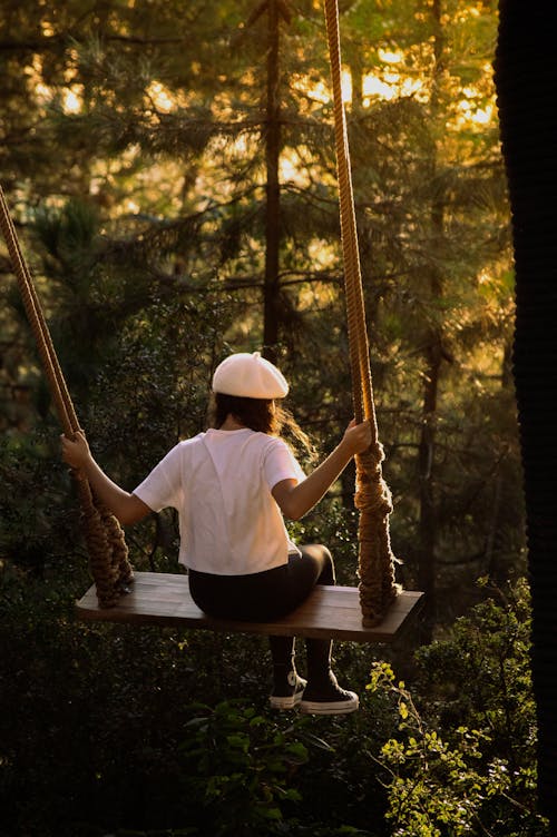 A Woman Sitting on a Swing