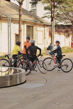 Cyclists resting in an urban area of Jakarta, Indonesia, enjoying leisure time.