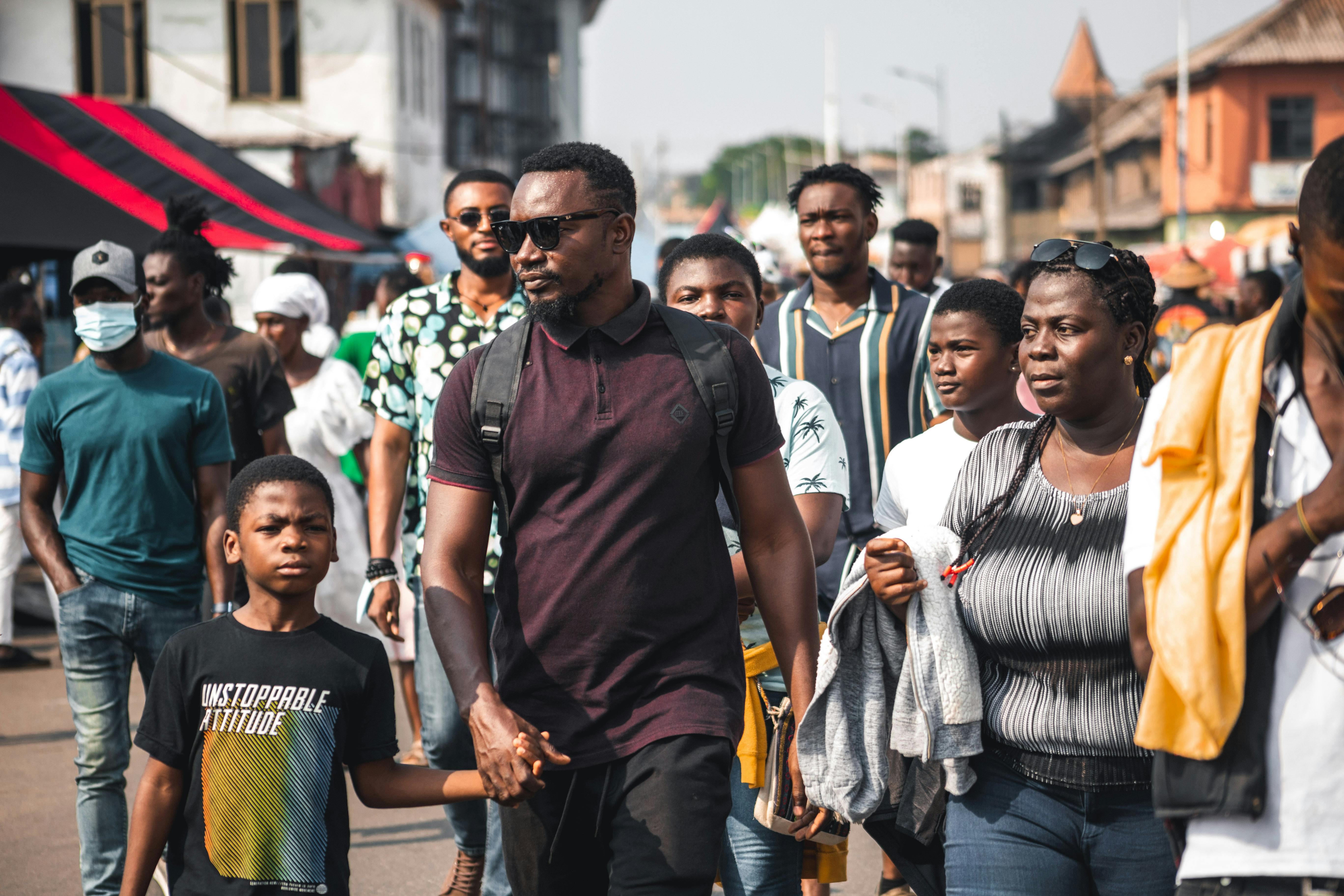 sunset over Ho, Ghana with people walking near Christ Embassy Loveworld Arena