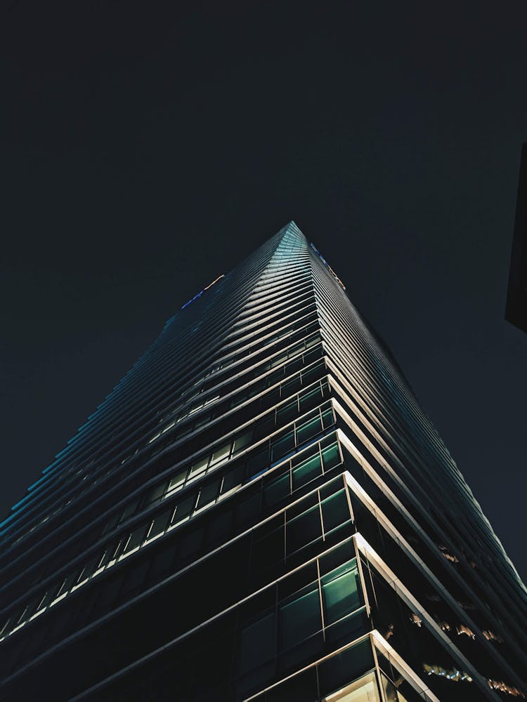 Low Angle View Of A Modern Skyscraper At Night 