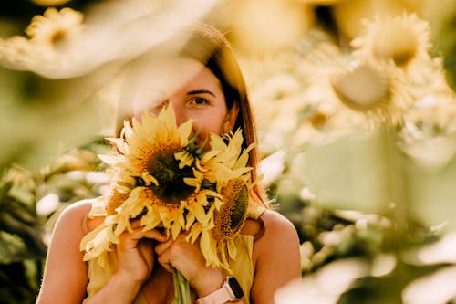 A Woman Holding Sunflowers