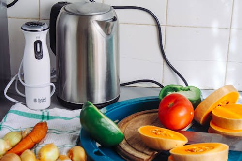 Free Gray Metal Electric Kettle Near Sliced Vegetables Stock Photo