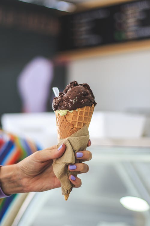 A Close-Up Shot of a Person Holding an Ice Cream