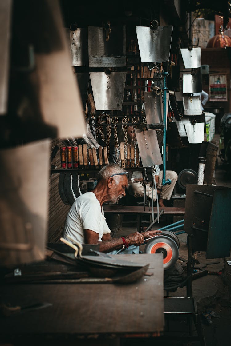 Old Man Working In Workshop