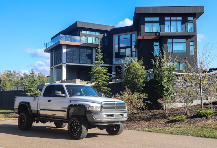 White Pick Up Truck Parked Near The Modern House