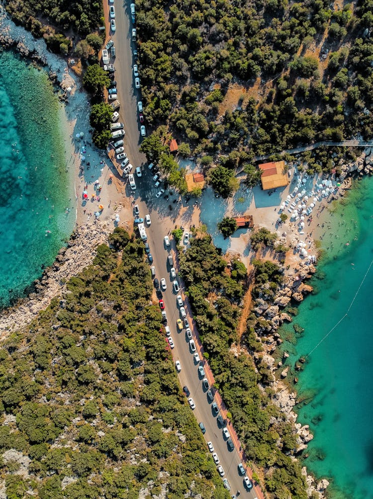 Aerial Shot Of Cars Parked On The Road Near The Ocean 