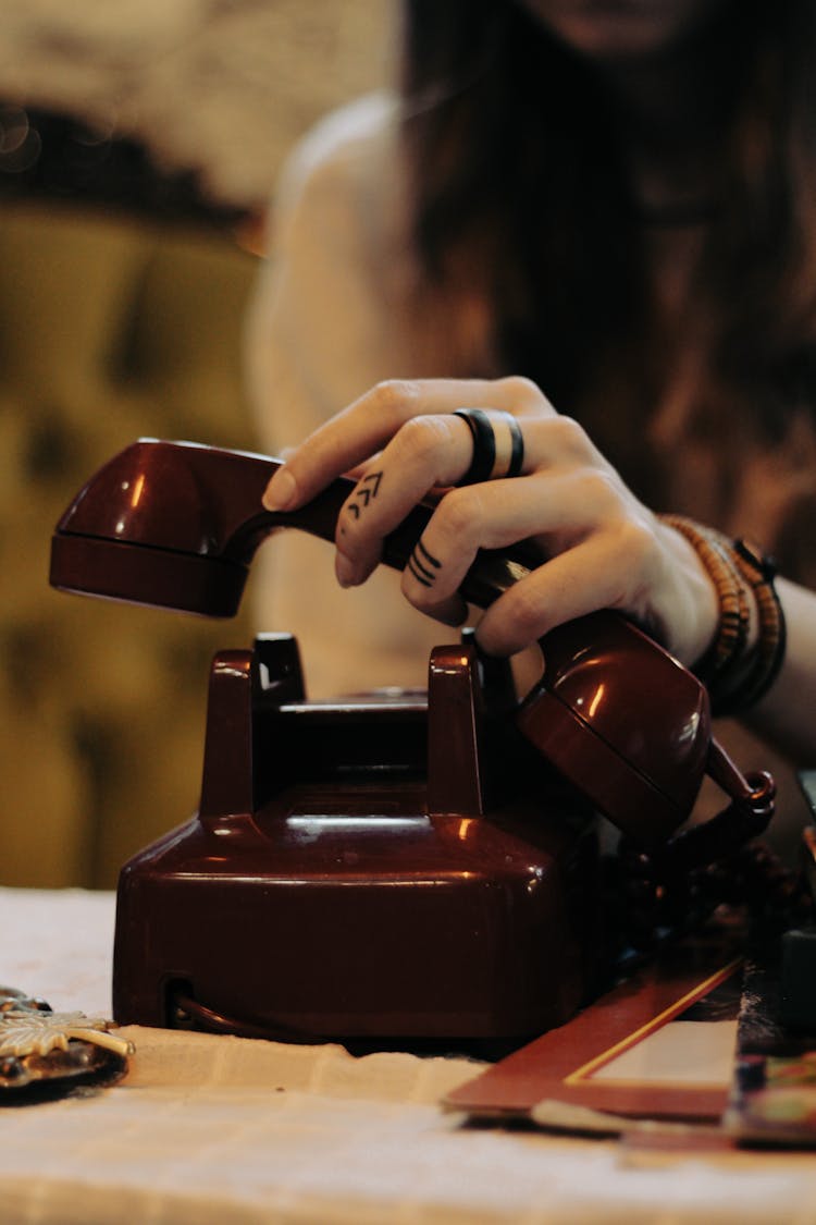 Person Holding A Desk Set Phone