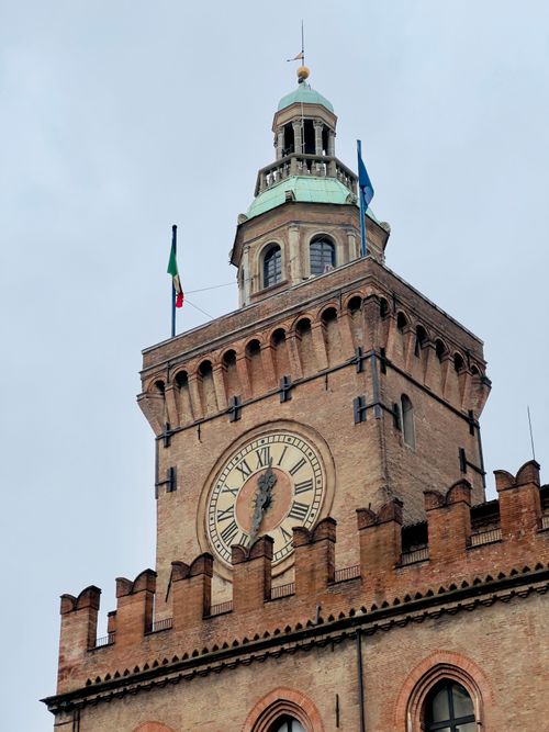 Free Historic Palazzo d'Accursio tower with clock under a cloudy sky in Bologna, Italy. Stock Photo