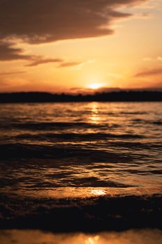 A captivating sunset casting warm hues over the rippling ocean waves, evoking tranquility and awe.