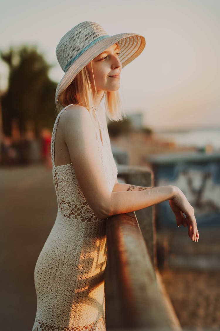 Woman In Summer Hat Posing On Beach On Dusk