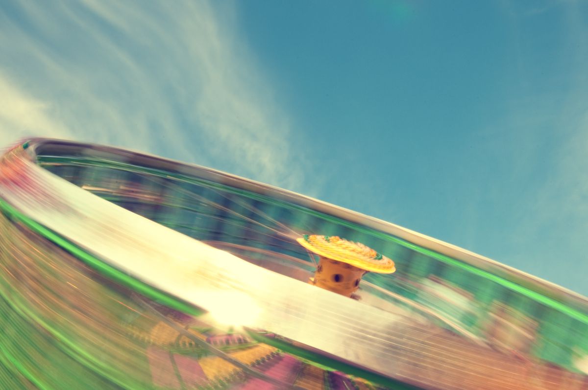 Spinning carnival ride capturing the motion and thrills of summer amusement parks