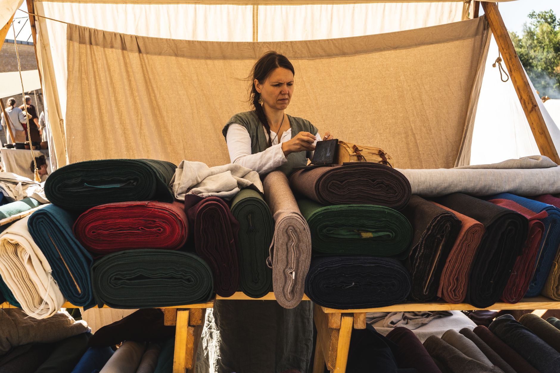 Woman Putting Bag Above Fabrics