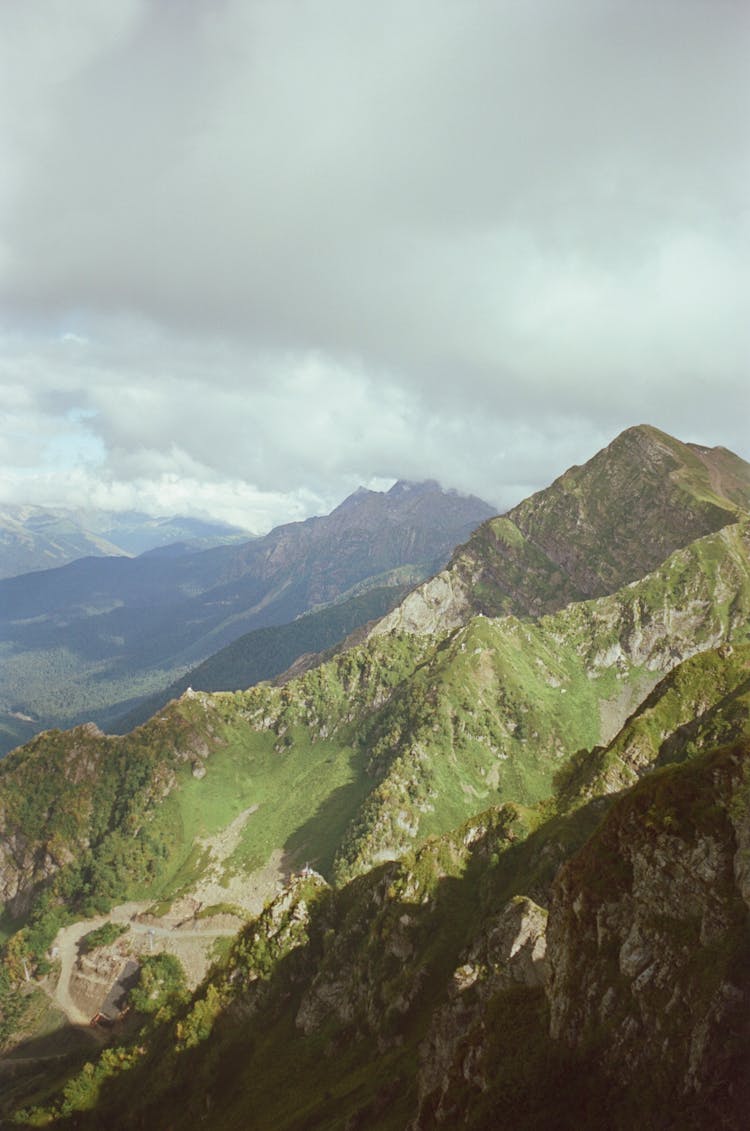 Landscape With Green Rocky Mountains And Clouds