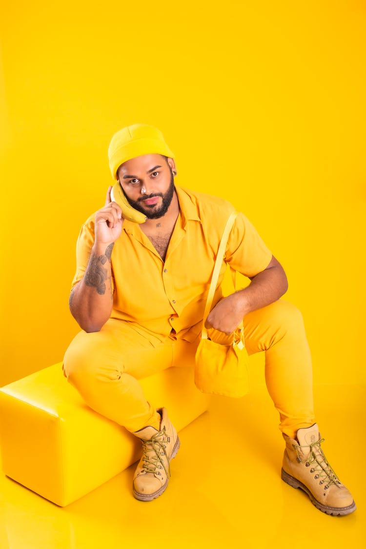 Bearded Man In Yellow Clothes Posing In Yellow Studio